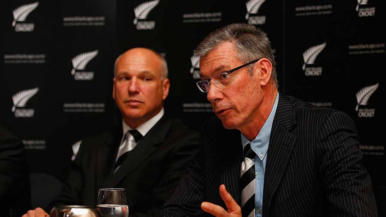 New Zealand Cricket chief executive David White looks on as John Buchanan speaks to the press
