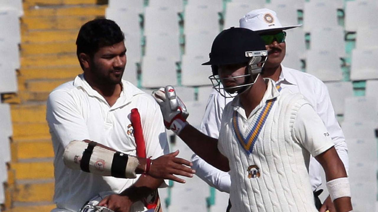 Karan Goel and Mandeep Singh walk off after securing victory, Punjab v Saurashtra, Ranji Trophy, Group A, Mohali, 3rd day, November 26, 2012