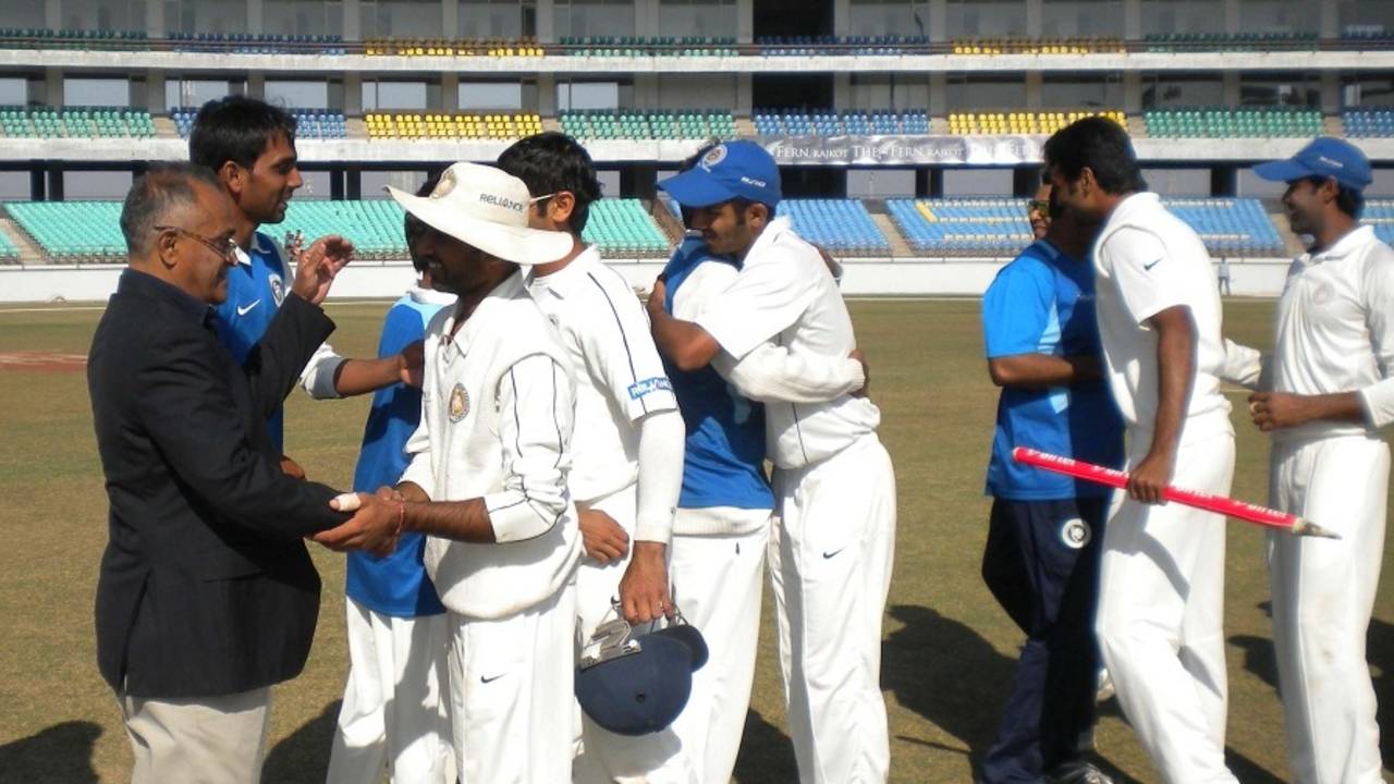 SCA secretary Niranjan Shah congratulates the Saurashtra players after the match, Saurashtra v Punjab, 1st semi-final, Ranji Trophy 2012-13, Rajkot, 5th day, January 20, 2013