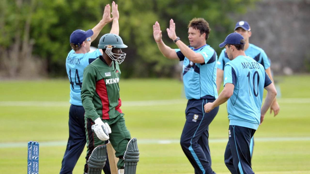 Neil Carter celebrates with team-mates after dismissing Alex Obanda, Scotland v Kenya, ICC World Cricket League Championship, Aberdeen, July 2, 2013
