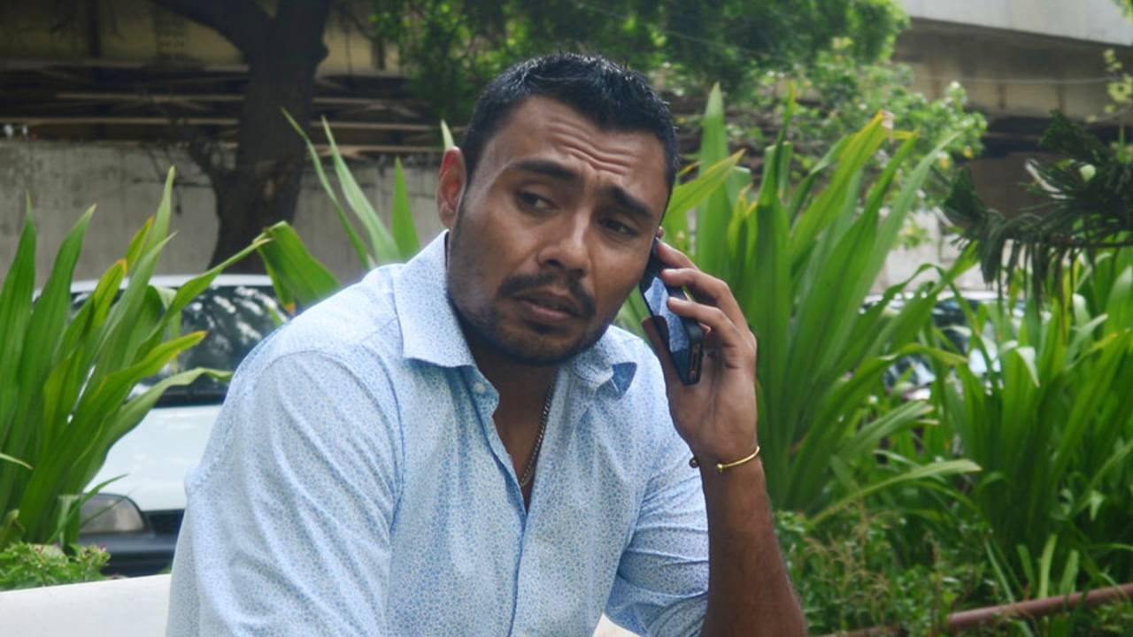 Danish Kaneria on the phone outside his apartment