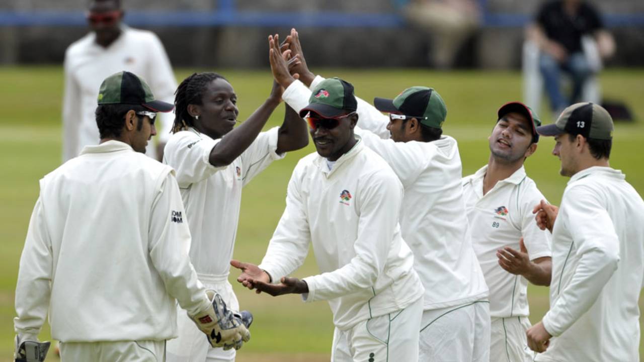 Nehemiah Odhiambo (second from left) celebrates a wicket