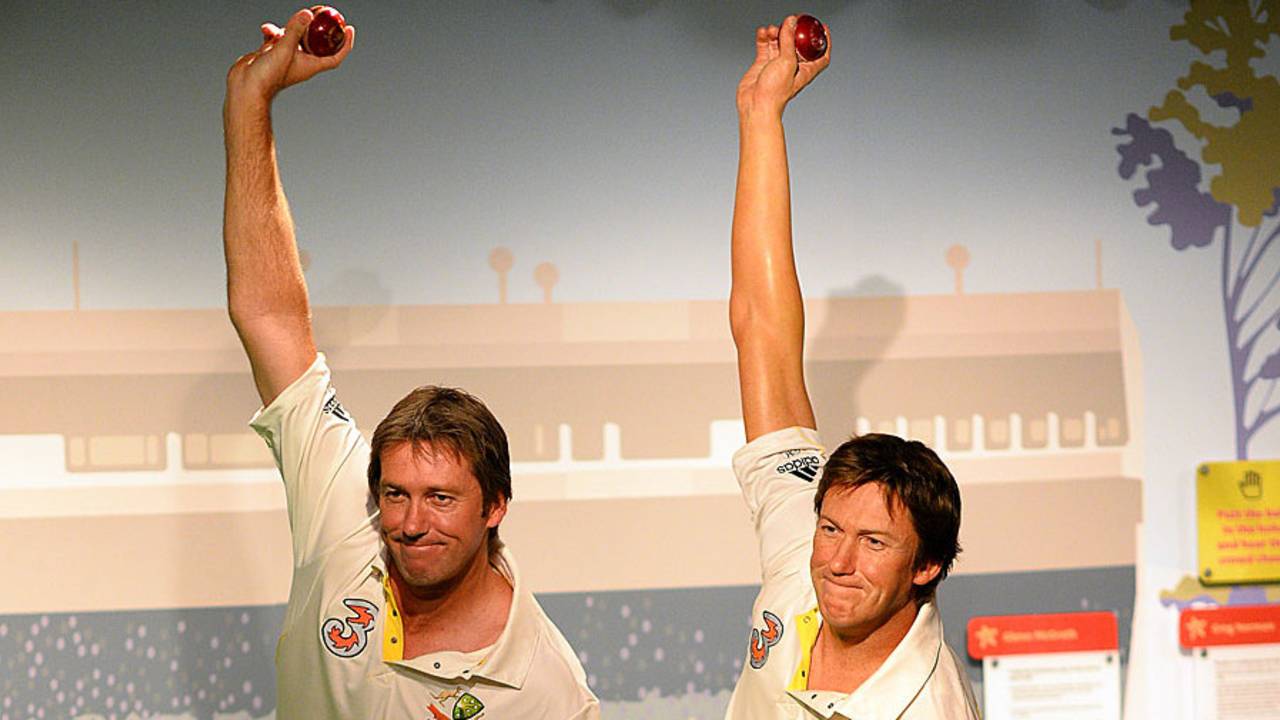 Glenn McGrath imitates the pose of a wax statue of himself at Madame Tussauds, Sydney, July 31, 2013 
