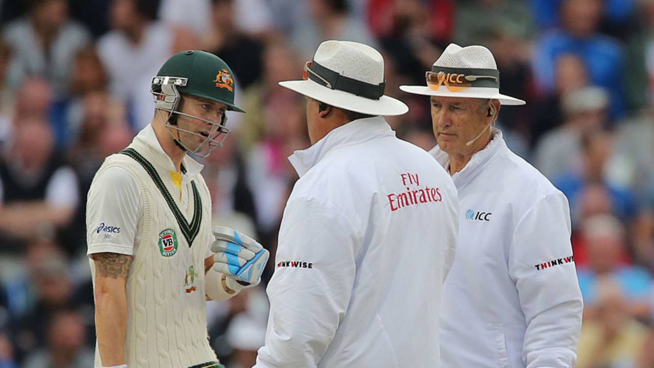 Michael Clarke chats animatedly with the umpires