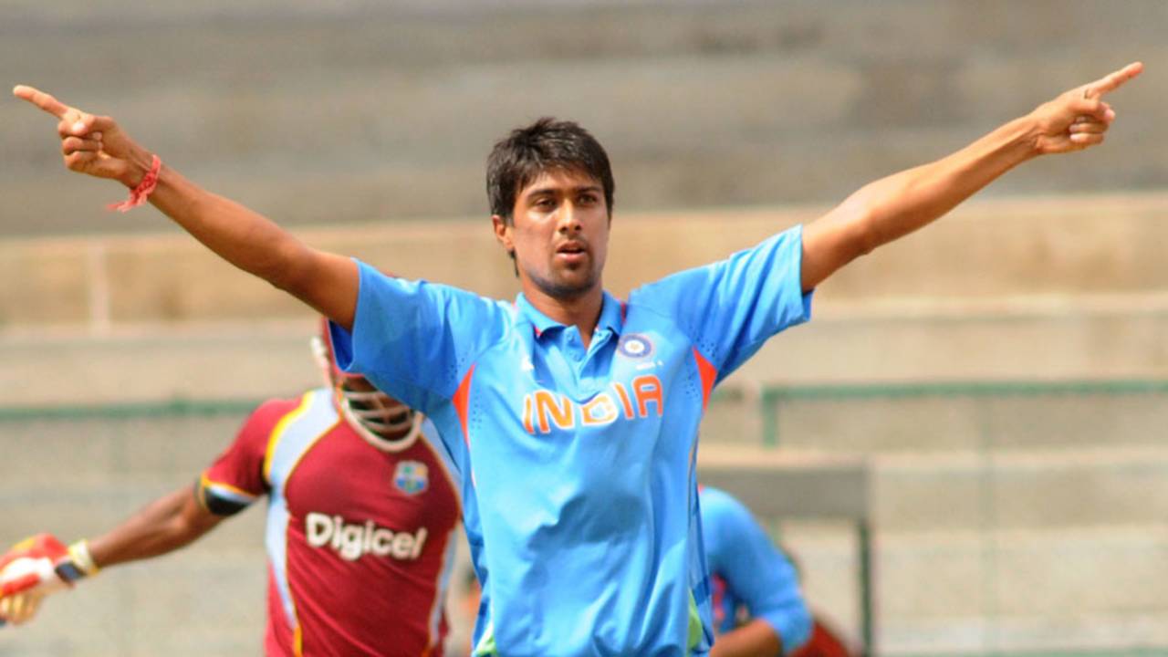 Rahul Sharma strikes a pose after knocking over another batsman