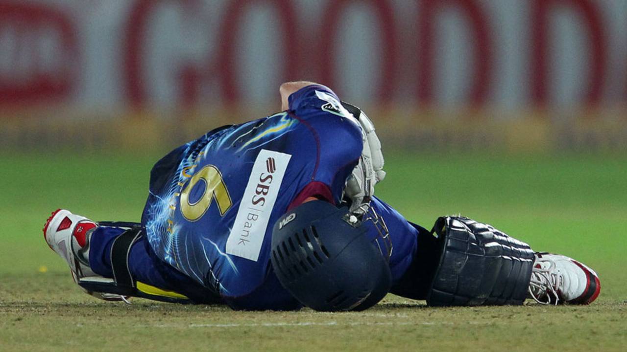Ian Butler is on the ground after being struck by a full toss, Lions v Otago, Group A, Champions League 2013, Jaipur, September 29, 2013