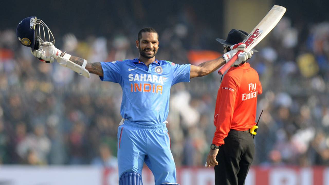 Shikhar Dhawan raises the bat after reaching his century, India v West Indies, 3rd ODI, Kanpur, November 27, 2013