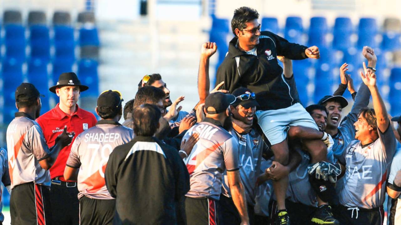 UAE players celebrate with coach Aaqib Javed after qualifying for the World T20, United Arab Emirates v Netherlands, quarter-final, ICC World Twenty20 Qualifier, Abu Dhabi, November 27, 2013