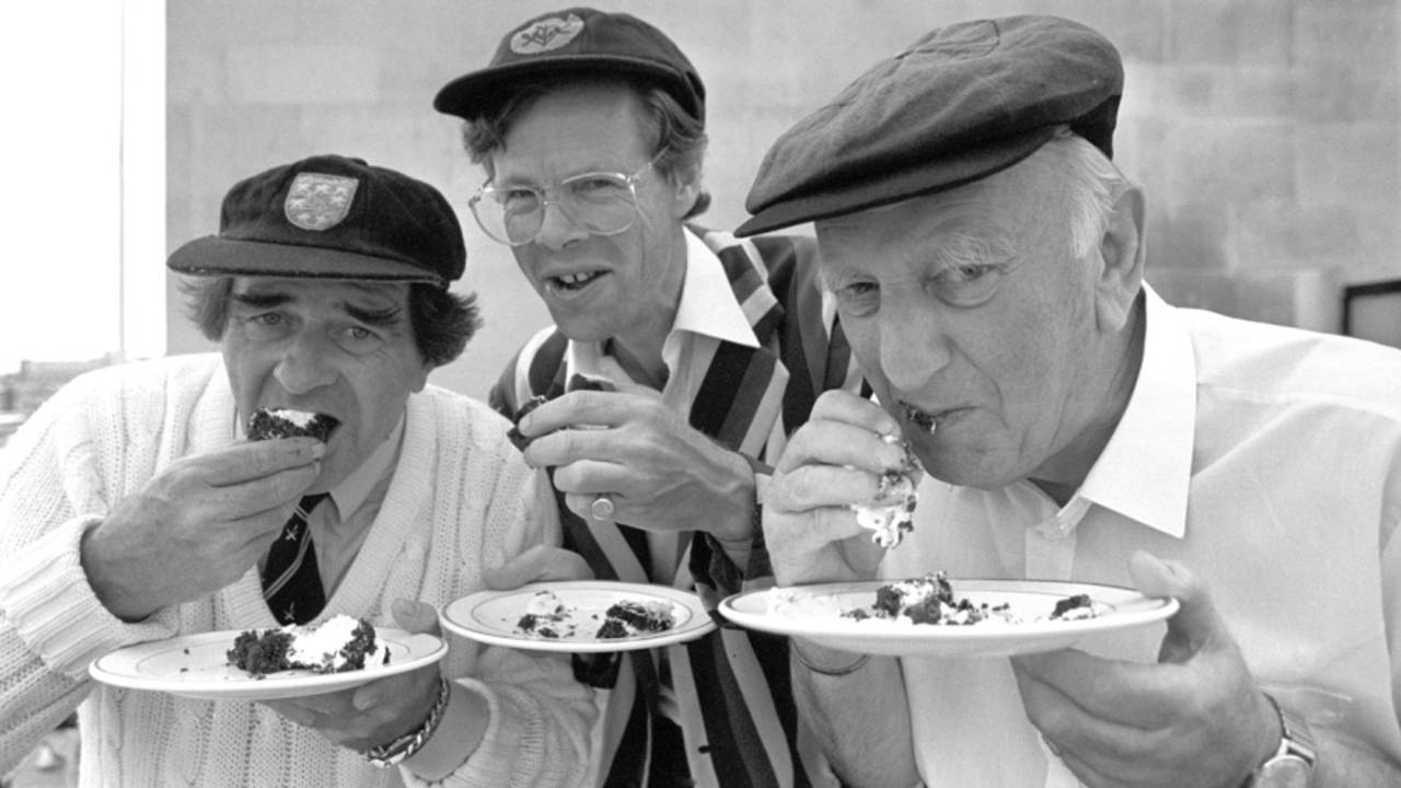 BBC commentators Fred Trueman, Christopher Martin-Jenkins and Brian Johnston eat cake, London, May 23, 1989