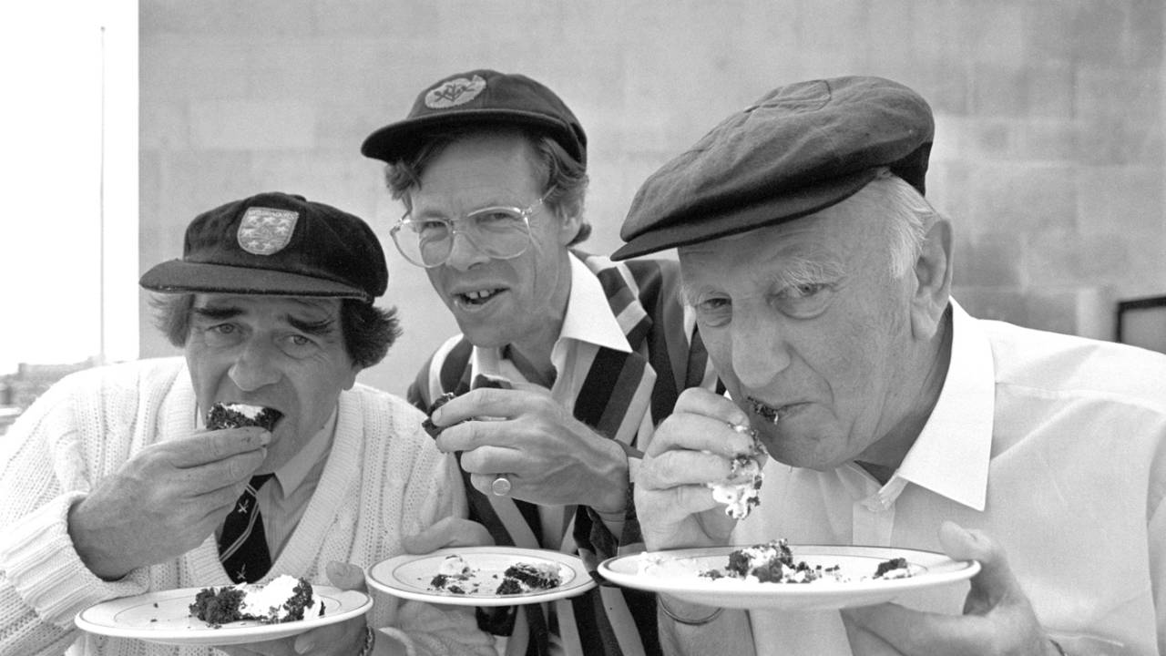 BBC commentators Fred Trueman, Christopher Martin-Jenkins and Brian Johnston eat cake, London, May 23, 1989