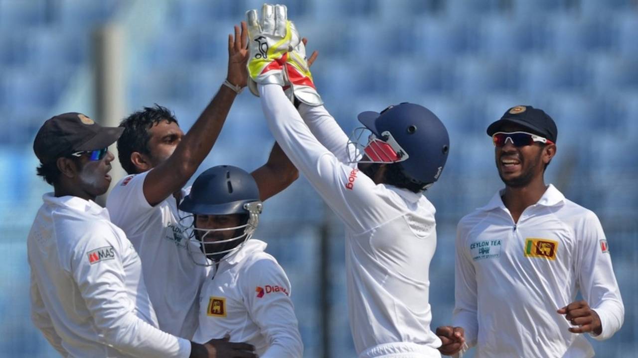 Dilruwan Perera is congratulated by Dinesh Chandimal after a wicket, Bangladesh v Sri Lanka, 2nd Test, Chittagong, 5th day, February 8, 2014