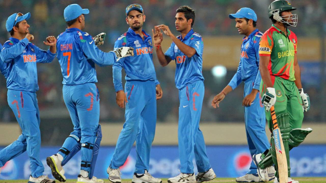 Team-mates congratulate Bhuvneshwar Kumar after Shakib Al Hasan's wicket, Bangladesh v India, World T20, Group 2, Mirpur, March 28, 2014