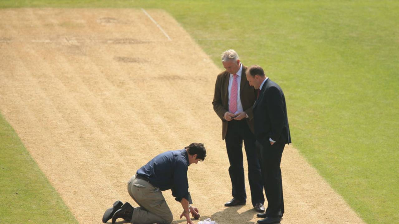 Tony Pigott and David Capel inspect the pitch