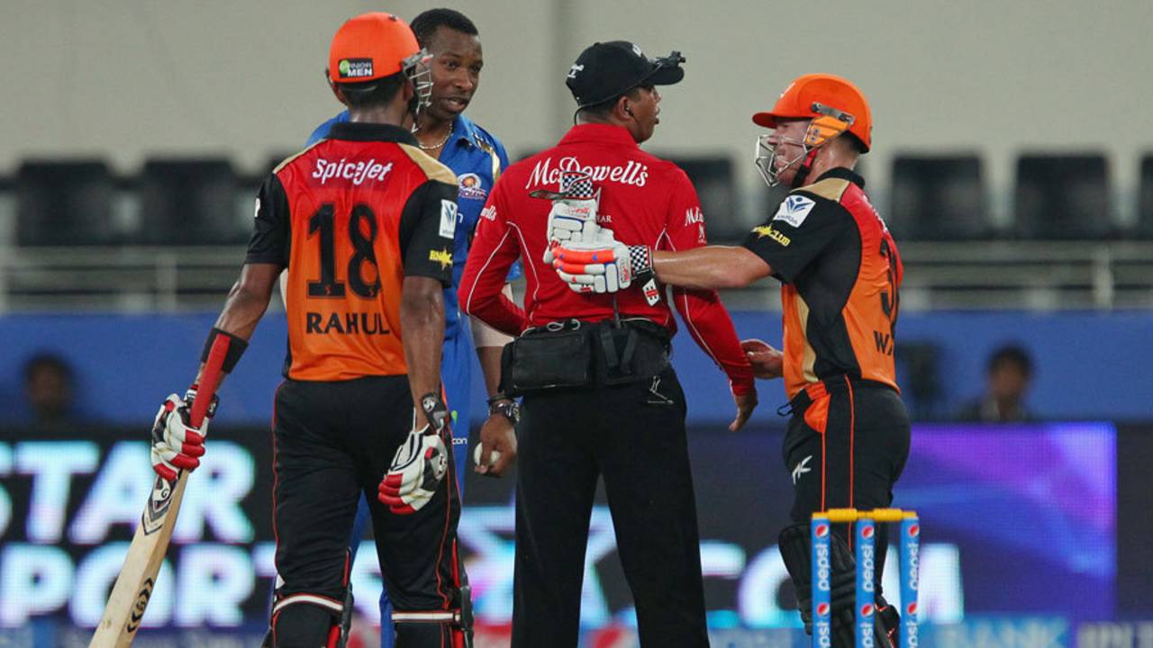 David Warner checks on umpire Kumar Dharmasena after the latter was hit by a ball, Mumbai Indians v Sunrisers Hyderabad, IPL 2014, Dubai, April 30, 2014