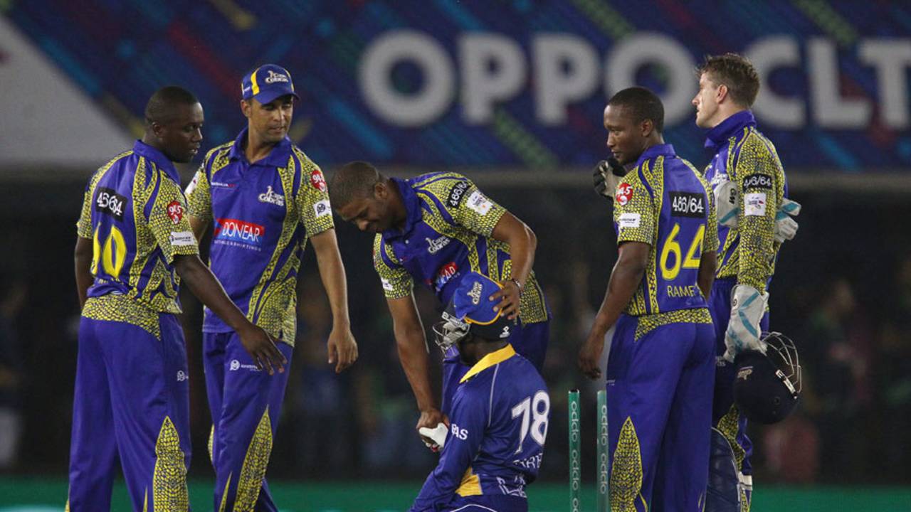 A distraught Jonathan Carter is consoled by the Cobras players, Barbados Tridents v Cape Cobras, Champions League T20, Group B, Mohali, September 26, 2014