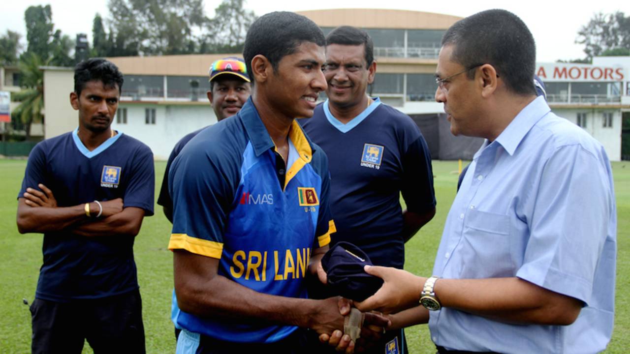 Thiran Dhanapala gets his Under-19 cap from Ranjan Madugalle, Colombo, October 3, 2014