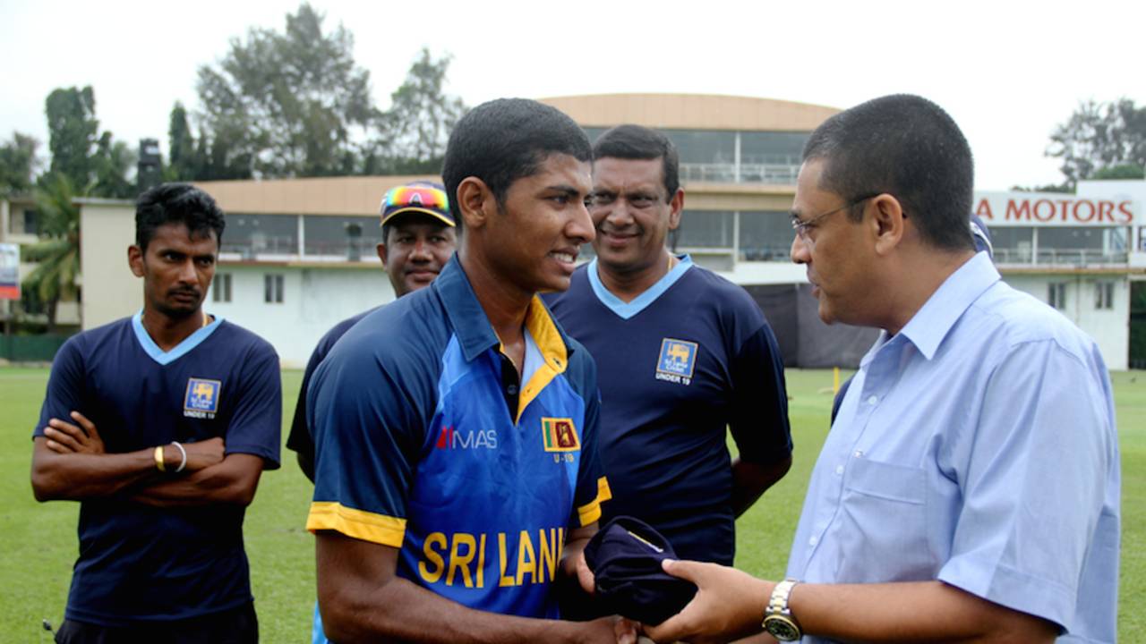 Thiran Dhanapala gets his Under-19 cap from Ranjan Madugalle, Colombo, October 3, 2014