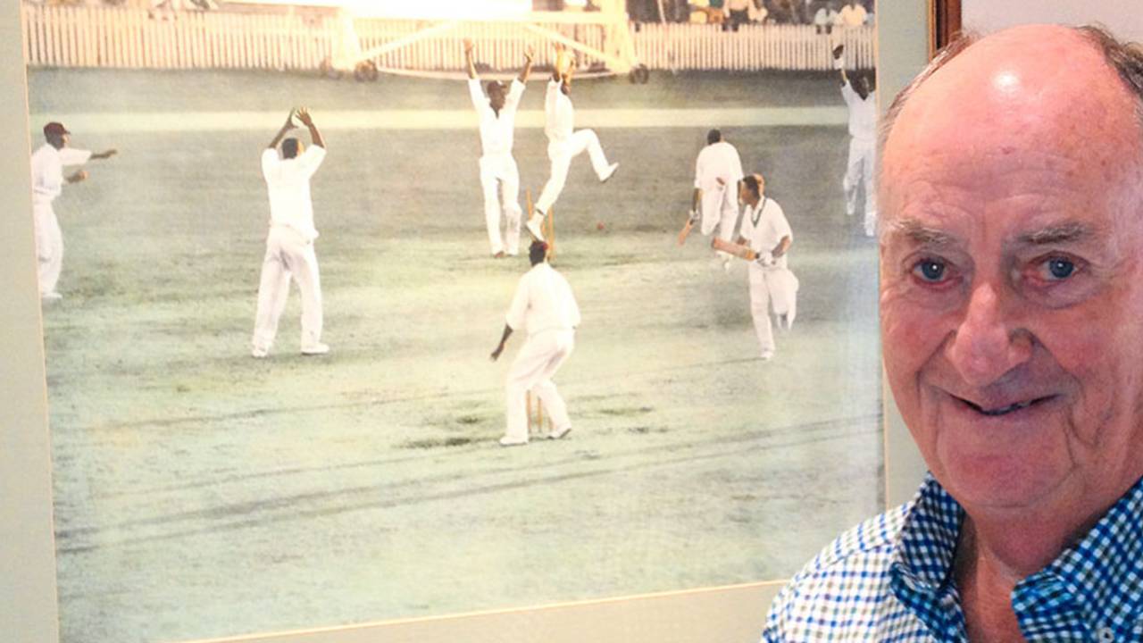 Ian Meckiff poses next to the picture of the tied Test at home, Melbourne