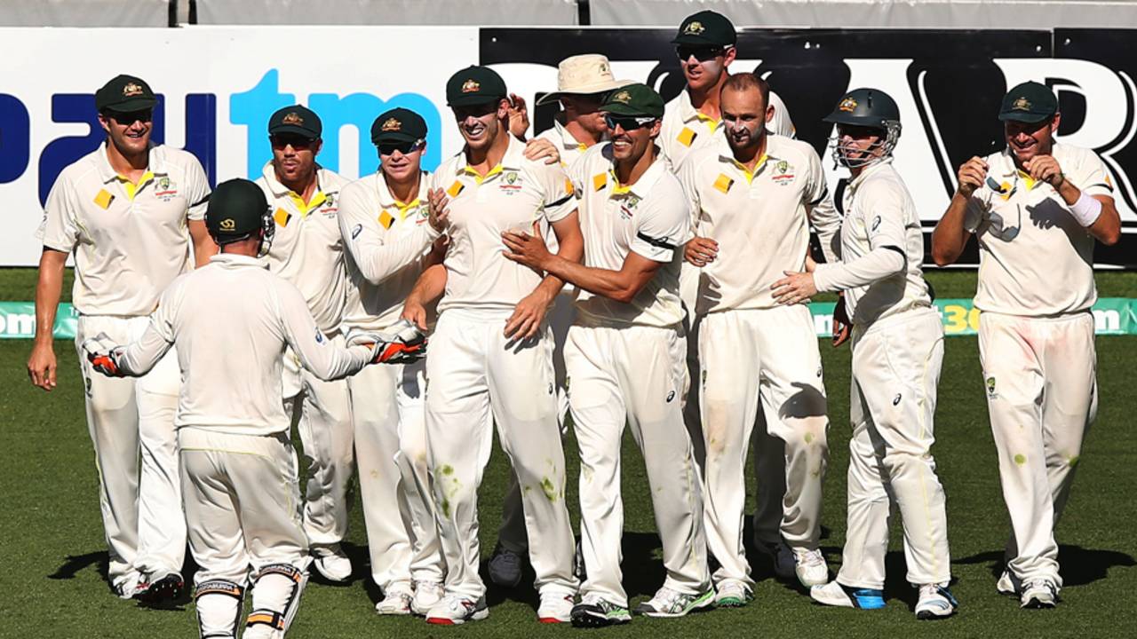 Australia gather around Mitch Marsh after he completes the catch to dismiss Virat Kohli, Australia v India, 1st Test, Adelaide, 5th day, December 13, 2014