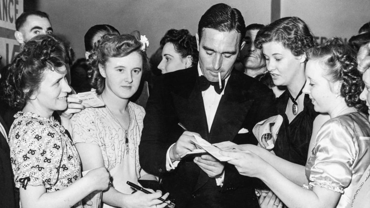 Denis Compton signs autographs for his fans at Empress Hall, London
