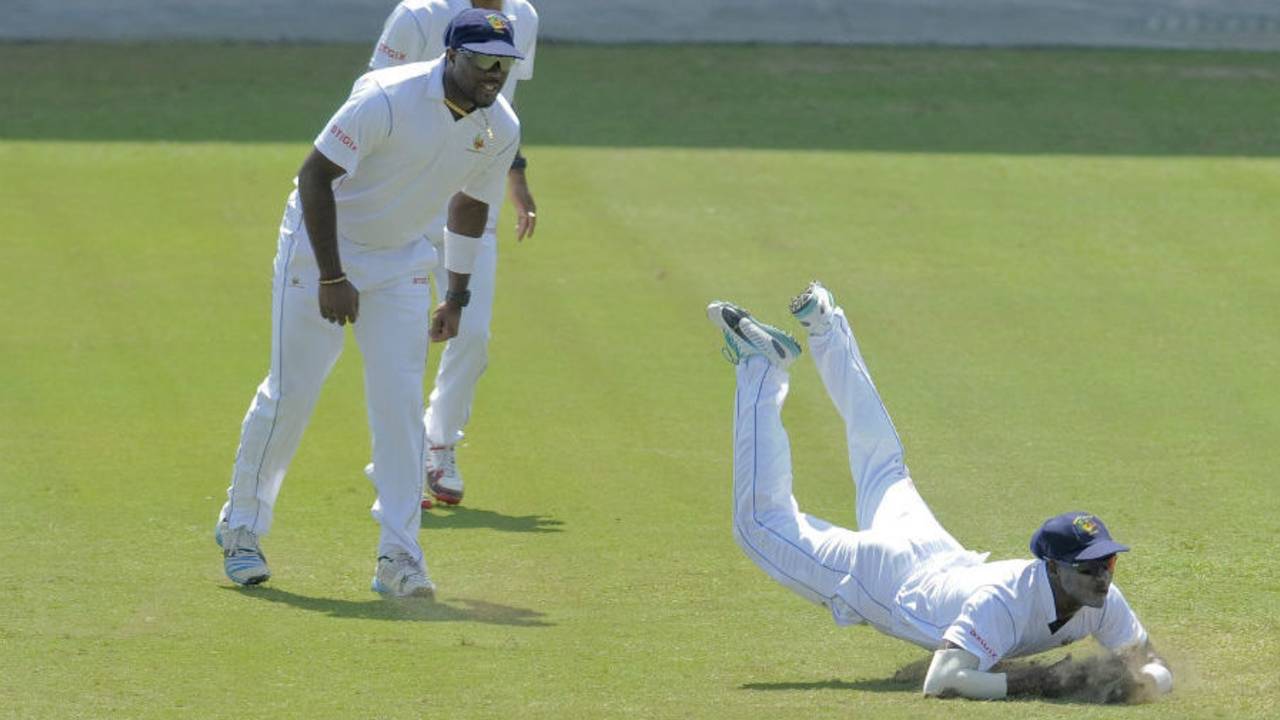 Ashley Nurse and Kraigg Brathwaite watch Kyle Corbin take a catch, Barbados v Leeward Islands, Regional 4 Day Tournament 2014-15, 3rd day, Bridgetown, February 8, 2015