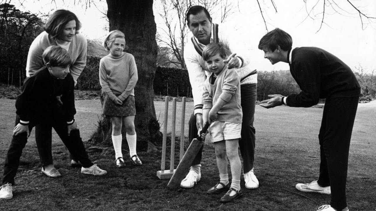 Colin Cowdrey teaches his family how to bat in the lawn of the family home in Surrey, England, April 1, 1970