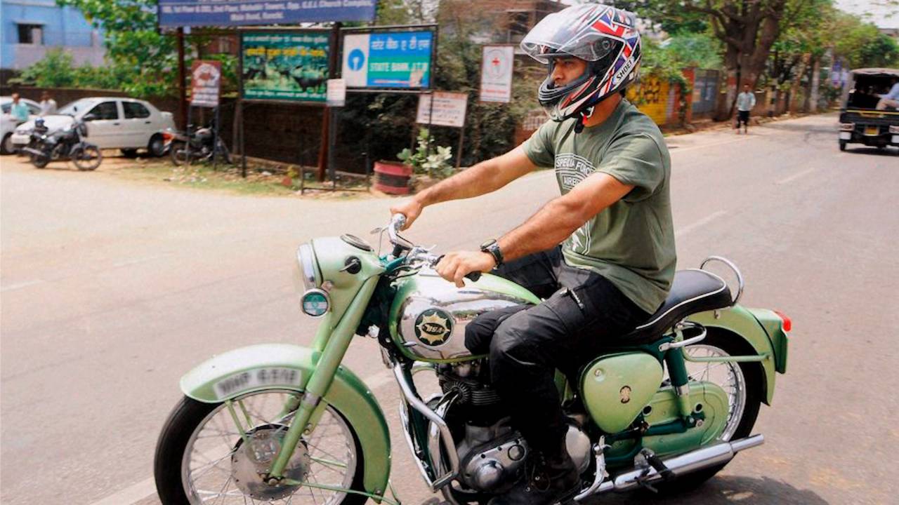 MS Dhoni rides a motorcycle in his hometown, Ranchi, April 6, 2015