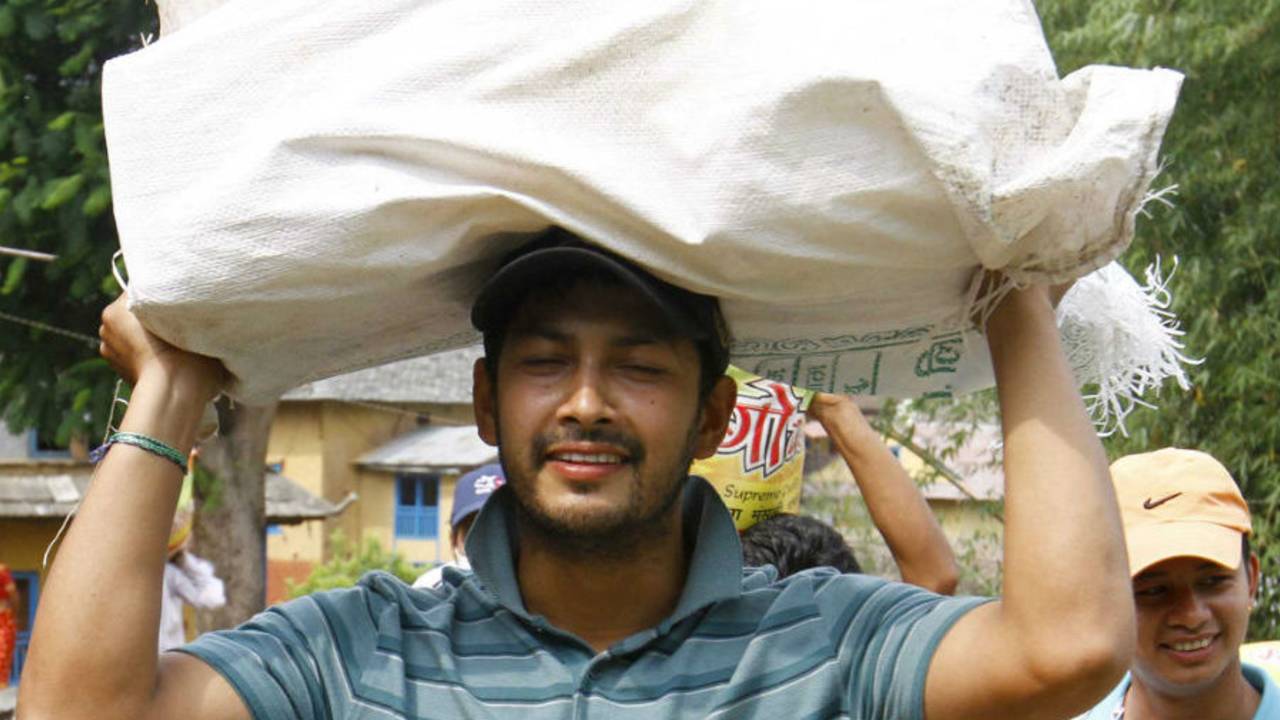 Subash Khakurel, wicket keeper batsman of the Nepal national cricket team carrying relief material to earthquake victims at Baseshwor VDC in Sindhuli on May 7 2015.