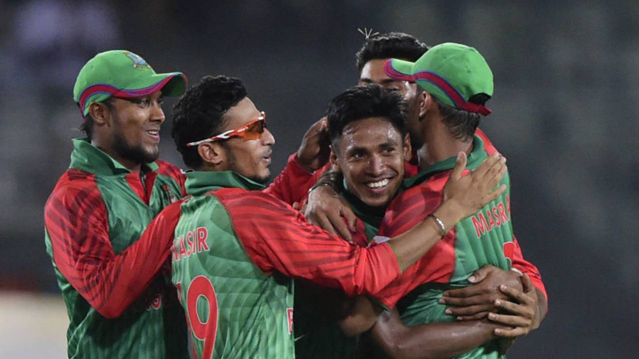 Mustafizur Rahman is mobbed by his team-mates after dismissing Ajinkya Rahane, Bangladesh v India, 1st ODI, Mirpur, June 18, 2015