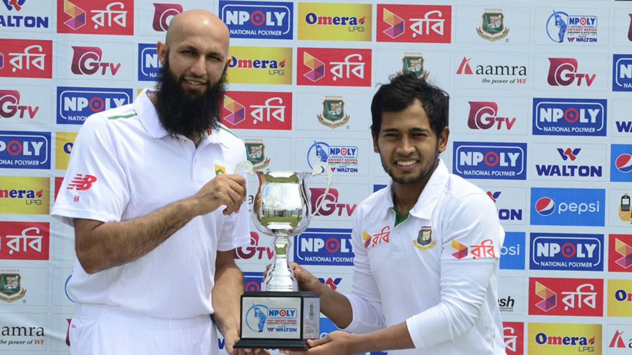 Mushfiqur Rahim and Hashim Amla pose with the trophy ahead of the first Test, Chittagong, July 20, 2015