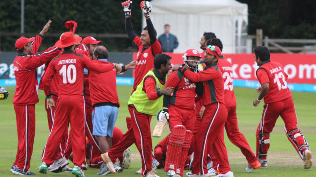 Zeeshan Siddiqui is mobbed by elated team-mates, Namibia v Oman, World T20 Qualifier, 4th qualifying playoff, Dublin, July 23, 2015