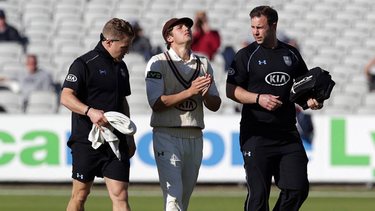 Zafar Ansari leaves the field after suffering a hand injury, Lancashire v Surrey, LV= County Championship, Division Two, Old Trafford, 2nd day, September 15, 2015