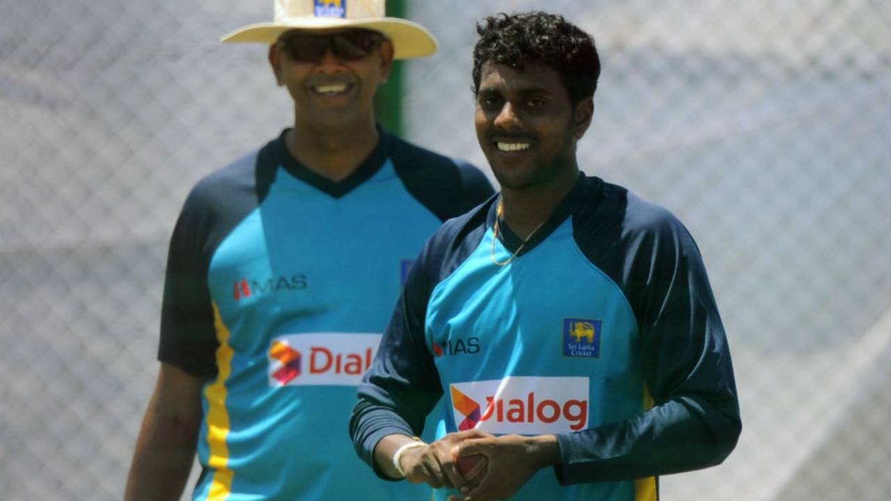 Tharindu Kaushal prepares to bowl under the watchful eyes of coach Jerome Jayaratne, Galle, October 13, 2015