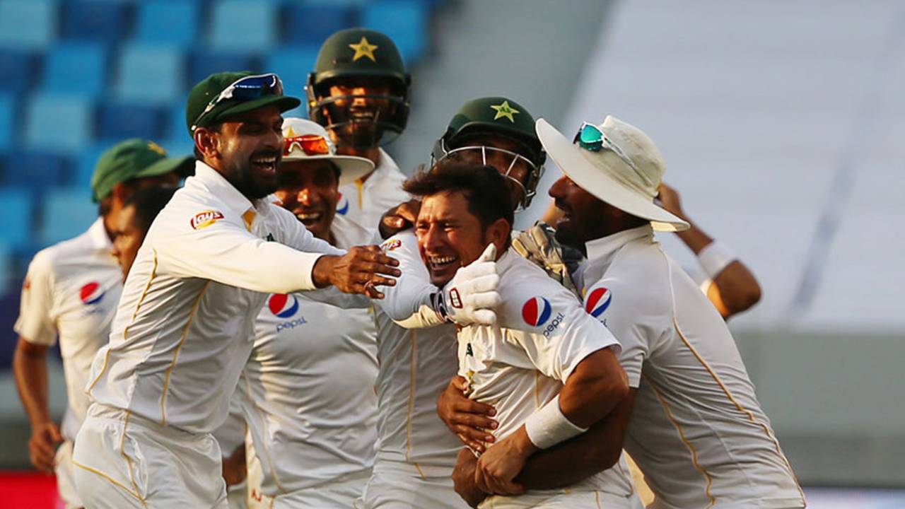 Pakistan's fielders mob Yasir Shah after Pakistan's thrilling win, Pakistan v England, 2nd Test, Dubai, 5th day, October 26, 2015