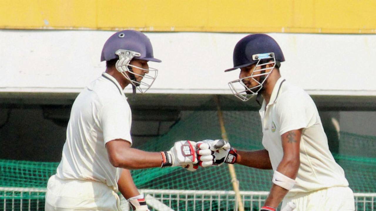 Ganesh Satish and S Badrinath punch gloves during their 127-run stand