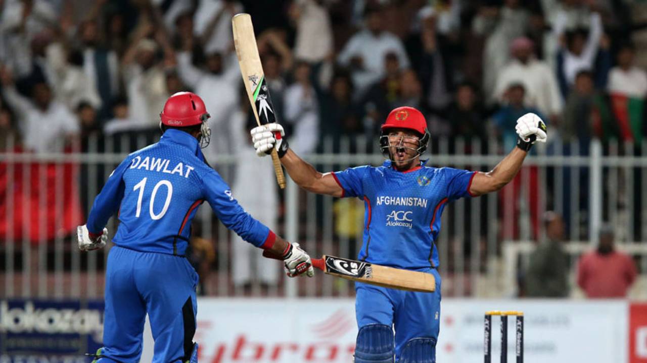 Gulbadin Naib and Dawlat Zadran celebrate Afghanistan's historic win, Afghanistan v Zimbabwe, 5th ODI, Sharjah, January 6, 2016