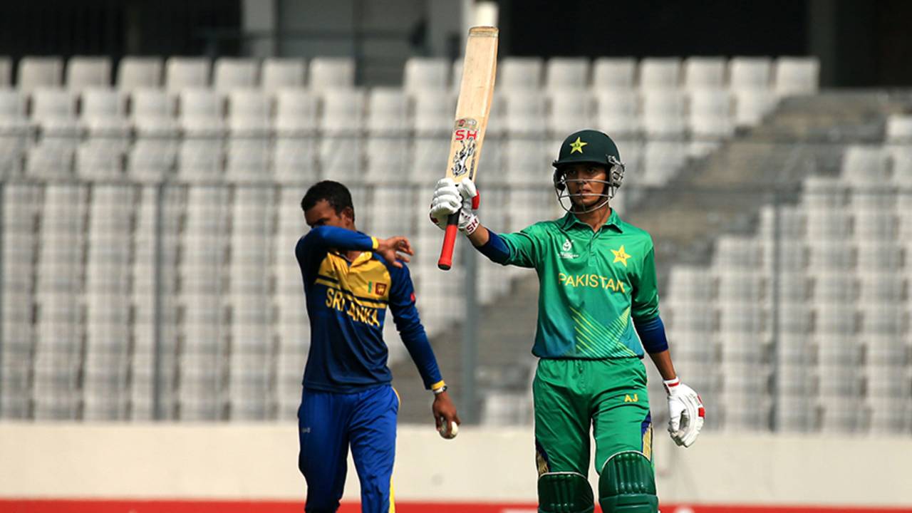 Hasan Mohsin raises his bat after scoring his first fifty of the tournament