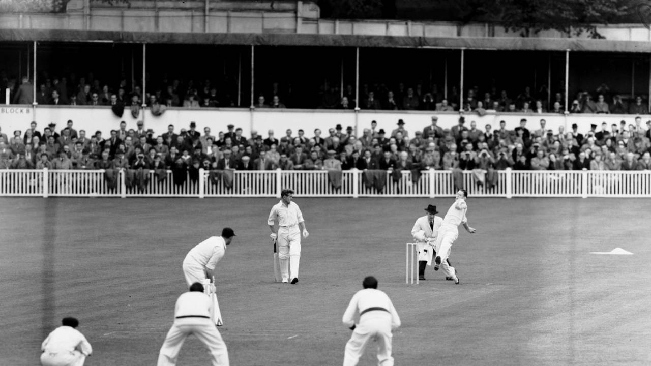 Fast bowler Pat Crawford bowls. Len Maddocks is the keeper