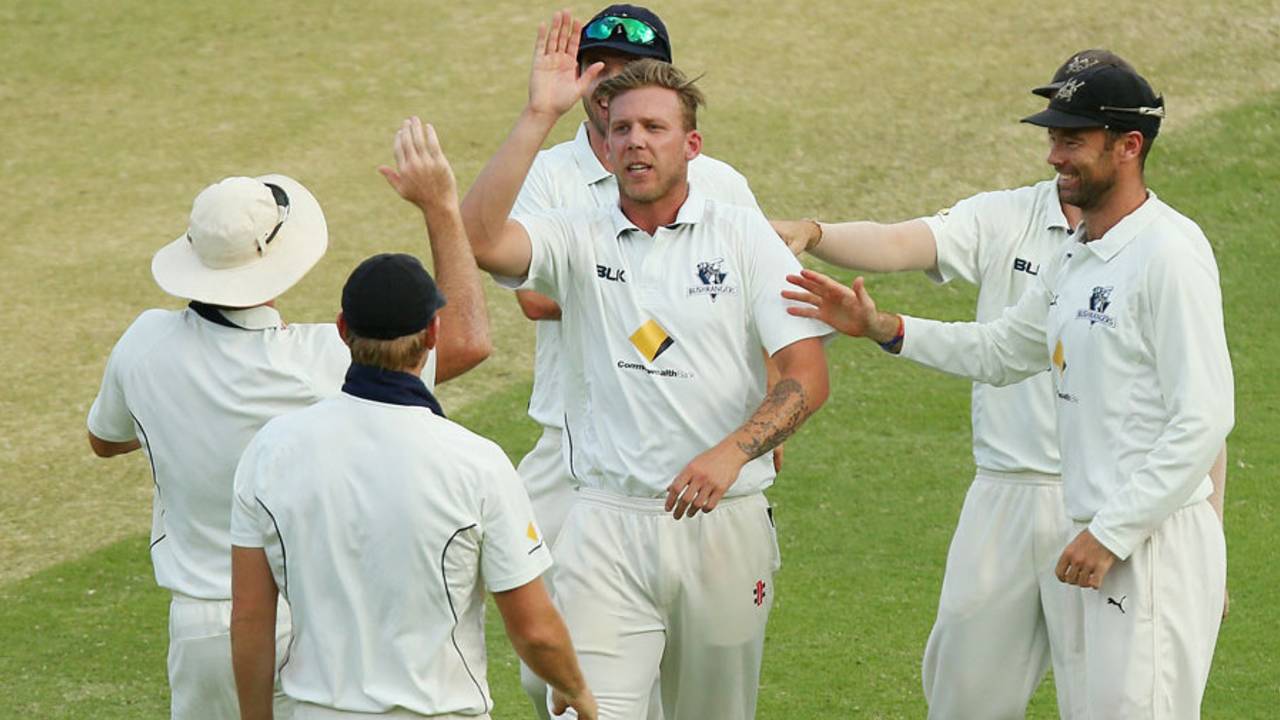 Jake Reed celebrates a wicket with his team-mates, Queensland v Victoria, Sheffield Shield, Brisbane, 2nd day, March 6, 2016