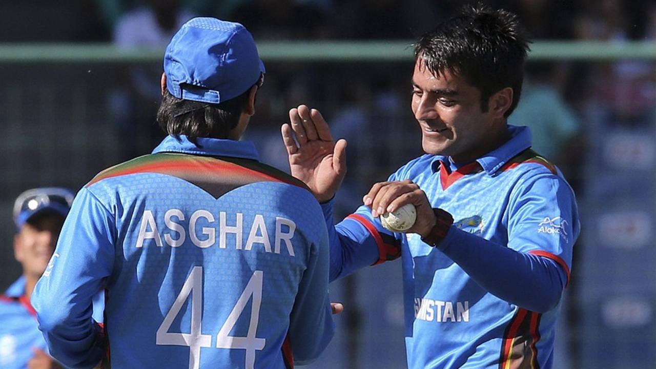 Rashid Khan celebrates a wicket with Asghar Stanikzai, Afghanistan v England, World T20 2016, Group 1, Delhi, March 23, 2016