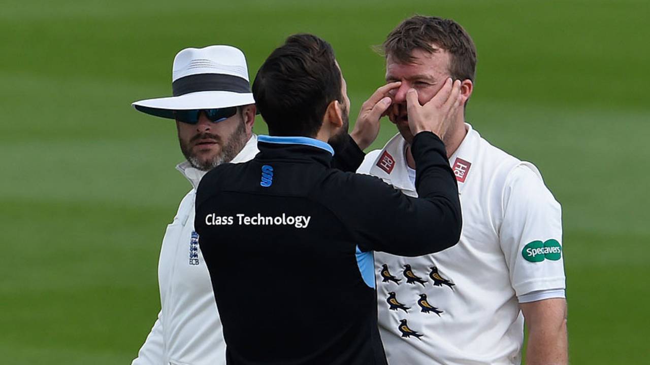 Chris Nash gets checked over by the physio after the blow to the helmet&nbsp;&nbsp;&bull;&nbsp;&nbsp;Getty Images