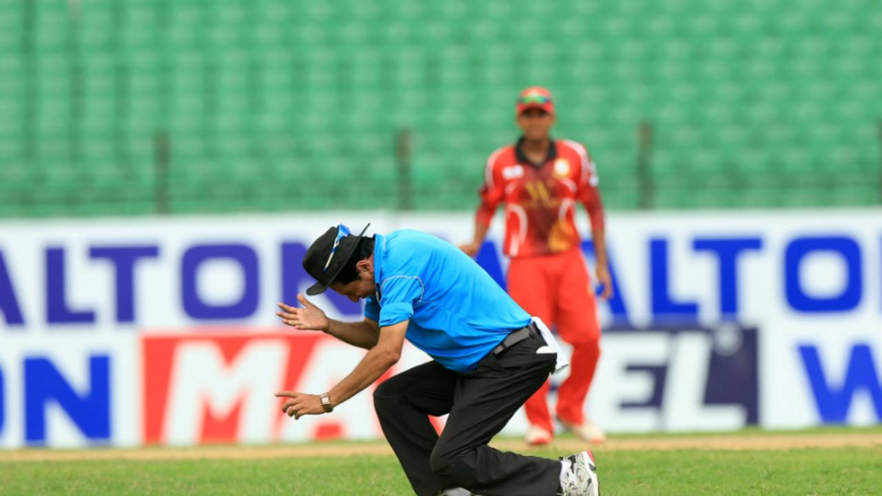 Umpire Nadir Shah collapses after being hit on the forehead