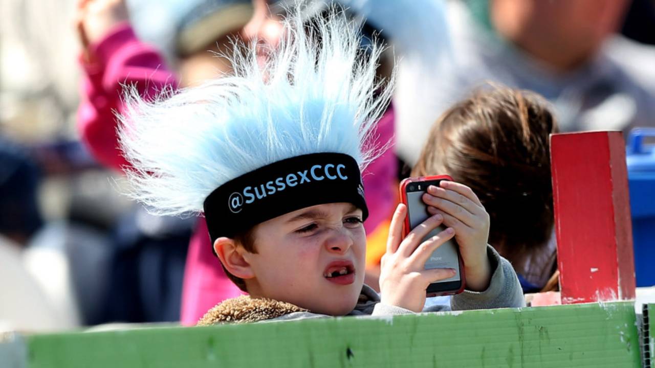 A young fan looks at his phone, Sussex v Gloucestershire, NatWest T20 Blast, South Group, Hove, May 17, 2015