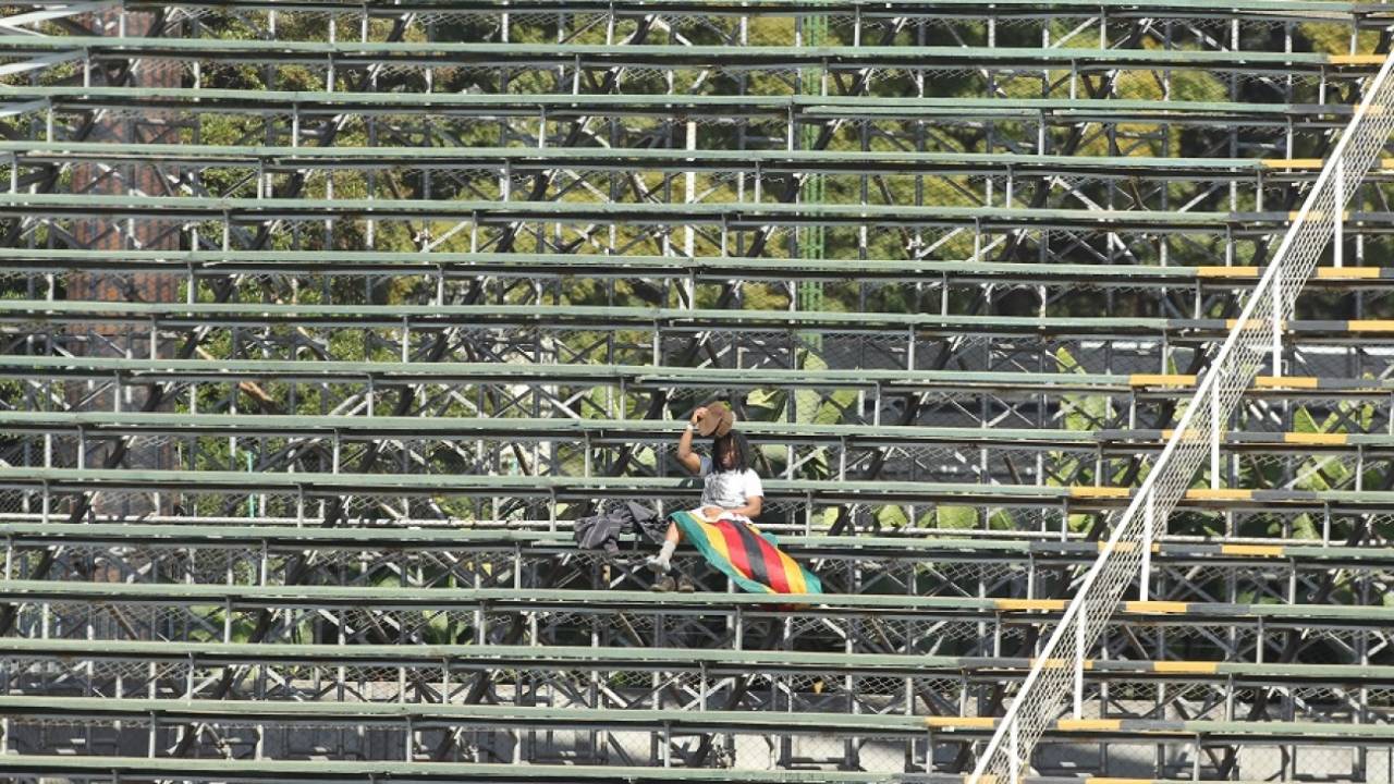 In the spotlight: A lone Zimbabwe fan takes cover from the sun , Zimbabwe v India, Harare, June 15, 2016
