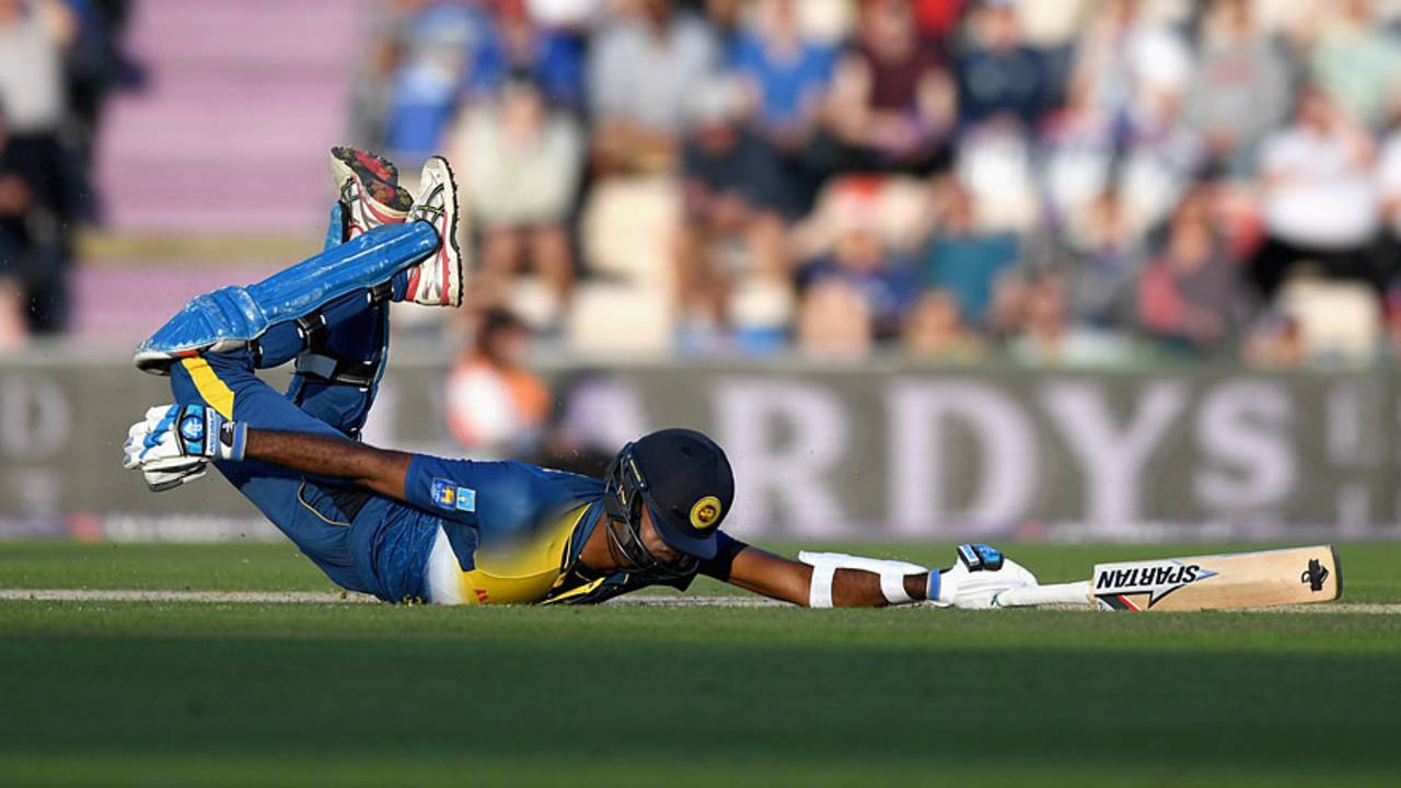 Farveez Maharoof dives to make his ground