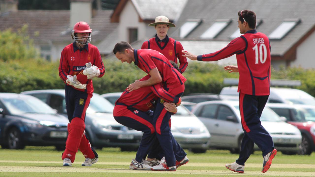 Anthony Hawkins-Kay lifts up Rob McBey after one of McBey's three wickets, Jersey v Guernsey, ICC World Cricket League Division Five, St Martin, May 25, 2016