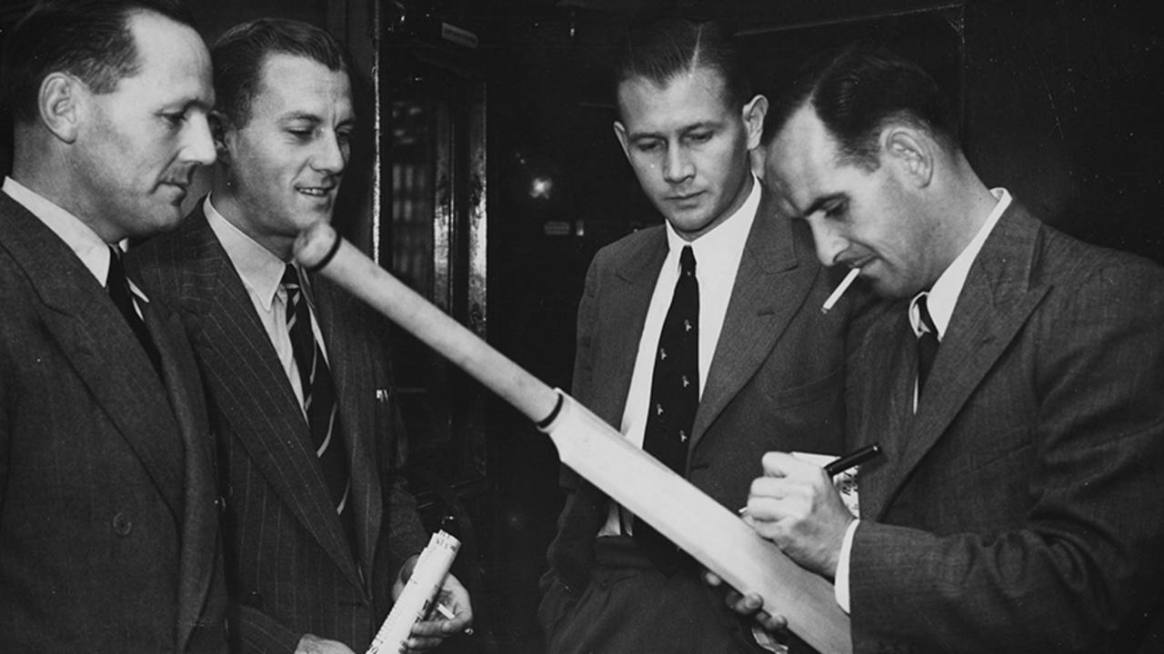 South Africa cricketers (L-R) Ken Viljoen, Athol Rowan, Lindsay Tuckett and Jack Plimsoll sign a bat, London, September 11, 1947