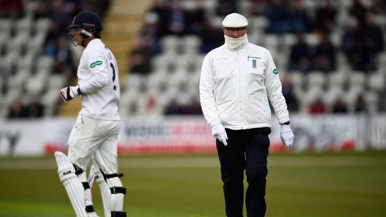 Umpire Neil Mallender feels the cold, Worcestershire v Essex, County Championship, Division Two, New Road, 2nd day, May 2, 2016