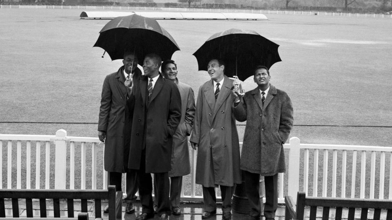 From left: Berkeley Gaskin (manager), Lester King, Deryck Murray, Willie Rodriguez and Joe Solomon of West Indies shelter from the rain that washed out the first day of the match, Worcestershire v West Indies, tour match, day one, May 1, 1963