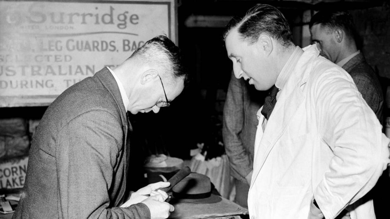 Walter Hadlee signs a bat during a visit to the Stuart Surridge factory, April 25, 1949